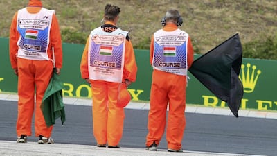 Race officials observe a minute of silence for the late Jules Bianchi before the start of the Hungarian Grand Prix. Bernadett Szabo / Reuters
