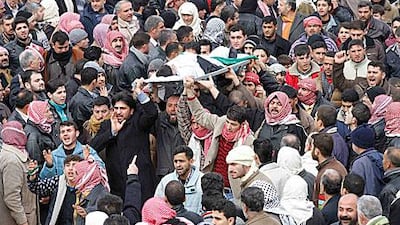 Mourners carry the body of a 10-year-old boy during a funeral for the child and rebel fighters killed during fighting in Idlib.