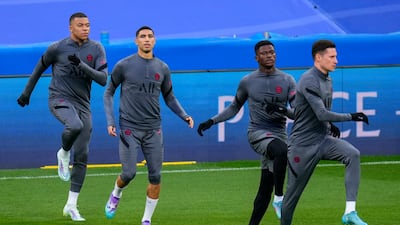 Kylian Mbappe, left, attends a training session with his teammates at the Bernabeu stadium. AP