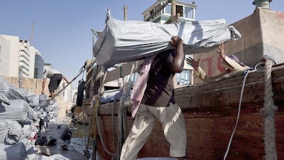 Labourers load a dhow in Dubai. Long before hydrocarbons, Hormuz was the hinge of a vast, interconnected system that Arab captains navigated with precision. Antonie Robertson / The National