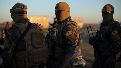 Fighters of Syrian Democratic Forces (SDF) stand together near the village of Baghouz, Deir Al Zor province, Syria. Reuters