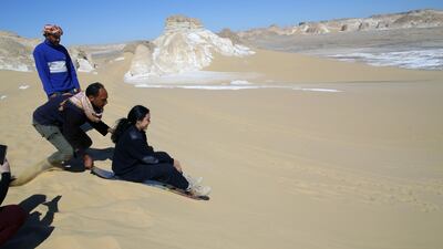 People skate on the sand at Maghrafa Mountain near Bawiti in Bahariya Oasis. EPA