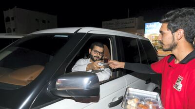 Salem Ahmed receives his tea. Chris Whiteoak / The National