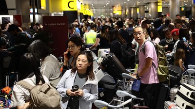 Delayed passengers wait and queue with their luggage at Terminal 3 of London Heathrow airport. AFP