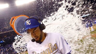 KANSAS CITY, MO - APRIL 03: Eric Hosmer #35 of the Kansas City Royals is doused with water by Salvador Perez #13 after the Royals defeated the New York Mets 4-3 to win their opening day game at Kauffman Stadium on April 3, 2016 in Kansas City, Missouri. Jamie Squire/Getty Images/AFP== FOR NEWSPAPERS, INTERNET, TELCOS & TELEVISION USE ONLY ==