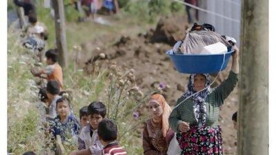 A Syrian refugee woman brings laundry to an irrigation canal in a camp, in Boynuyogun, Turkey, yesterday. The number of Syrian refugees in Turkey stands at more than 8,500 people.