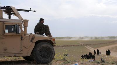 A fighter of Syrian Democratic Forces (SDF) sits on a vehicle near Baghouz, Deir Al Zor province, Syria. Reuters