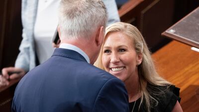 Republican Marjorie Taylor Greene speaks with Mr McCarthy. EPA
