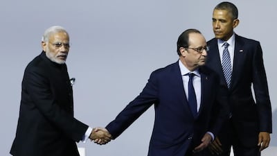French president Francois Hollande appeared in a hurry as he shook hands with Indian prime minister Narendra Modi at the opening day of the World Climate Change Conference in Paris. Ian Langsdon / AFP