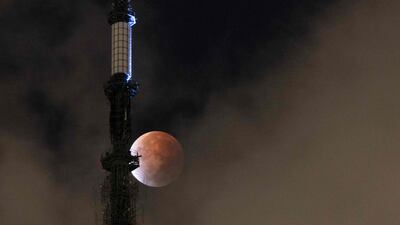 The Moon during a lunar eclipse behind the One World Trade Centre in New York early on November 19, 2021. AFP