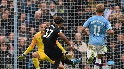 Traore scores the opening goal past Manchester City's Brazilian goalkeeper Ederson. AFP