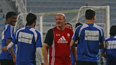 Dominique Bathenay, centre, puts his players through their paces at the Al Maktoom Stadium.