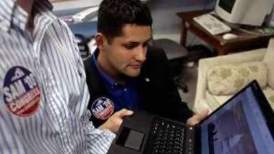 The US congressional candidate, Sam Rasoul, looks over campaign material.