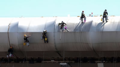 Workers clean the roof of Akron Stadium in Guadalajara. AFP
