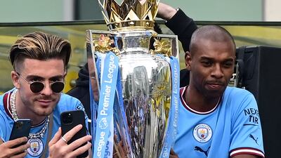 Jack Grealish and Fernandinho with the Premier League trophy. AFP