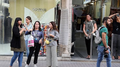 Participants receive food and culture insight from Tanya Rehman (first from left) of Frying Pan Adventures and photography expertise and assistance from instructor Kathleen Hoare (third from left) of Gulf Photo Plus. Pawan Singh / The National