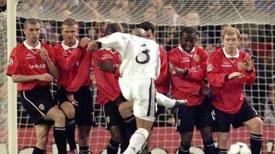 Real Madrid's Roberto Carlos tries to shoot past Manchester United defenders (from left, Roy Keane, David Beckham, Andrew Cole, Ryan Giggs, Dwight Yorke and Paul Scholes) in 2002.