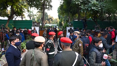Security and media personnel outside the entrance to Gen Bipin Rawat's house in New Delhi on December 8, 2021. AFP