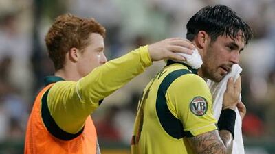 Australian cricketer Mitchell Johnson tries off with a cold towel during the ODI in Abu Dhabi.
