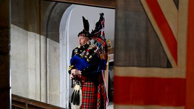 Pipe Major Paul Burns of the Royal Regiment of Scotland helps to close Queen Elizabeth II's state funeral last month. Getty Images