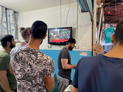 Palestinians watch rolling news coverage of violence in Jerusalem from a cafe in Beirut’s Shatila refugee camp. Gareth Browne / The National