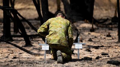 Lieutenant Kynan Lang from the 10th/27th Battalion visits the scene where his uncle and cousin died in a bushfire to place a memorial on Kangaroo Island, Australia. Reuters