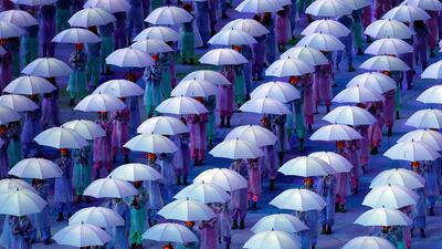 Performers with umbrellas at the Olympic Stadium. Lefteris Pitarakis/AP