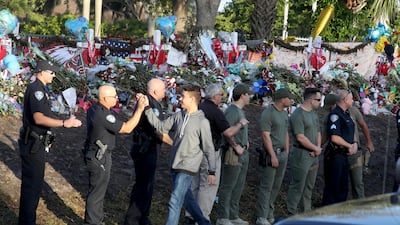 Students are greeted by law enforcement as they head back to school at Marjory Stoneman Douglas High School. Mike Stocker/South Florida Sun-Sentinel via AP
