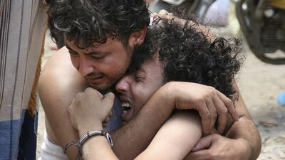 A man comforts another, whose brother was killed by a mortar shell blast during clashes between Houthis and fighters of the Popular Resistance Committees in Yemen's southwestern city of Taez on May 26, 2015. Reuters