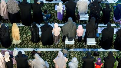 Women and girls pray in the women's section of the mosque.