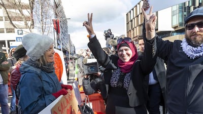 Survivors of a deadly mosque shooting celebrate with supporters after Brenton Tarrant was sentenced to life in prison, outside the High Court in Christchurch, New Zealand. EPA