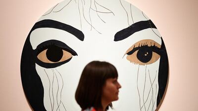 epa06843654 A woman stands near the Gary Holmes' work 'Michael' during a press preview of the exhibition "Michael Jackson: On the Wall" at the National Portrait Gallery in London, Britain, on June 27, 2018. Neil Hall / EPA