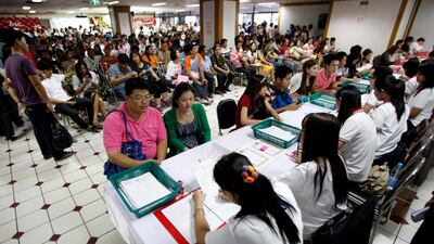Thai couples wait to register for their marriage certificates as part of Valentine's Day celebrations in Bangkok February 14, 2012. REUTERS/Chaiwat Subprasom