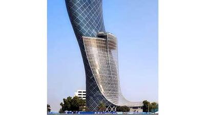 The Capital Gate tower, left, is nearly five times more inclined than the Leaning Tower of Pisa in Italy.