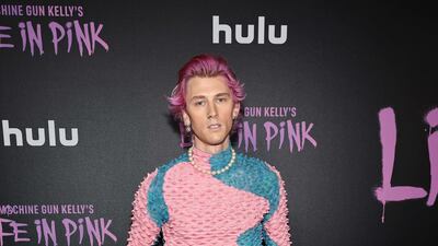 Musician Machine Gun Kelly with pink hair and a pink jumper at the premiere of the film 'Machine Gun Kelly's Life In Pink' in June. Getty