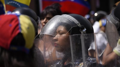 Bolivarian National Police officers stand in formation during an anti-government protest in Caracas, Venezuela. Bloomberg