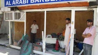 Anwar Hadir, right, is trying to gather enough money to reopen his barber shop.
