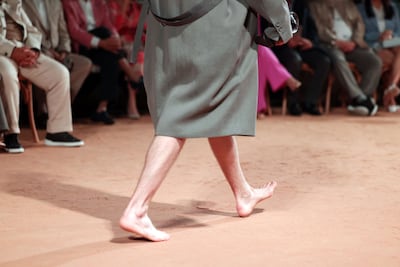 A model walks barefoot on the sandy runway at the Zegna spring/summer 2026 show at Dubai Opera. Chris Whiteoak / The National