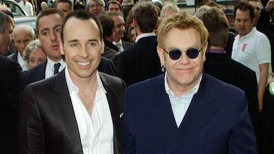 David Furnish and Elton John, wearing a navy suit, arrive at the 'Billy Elliot: The Musical' premiere at the Victoria Palace Theatre, London on May 12, 2005. Getty Images