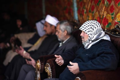 People console Louai Al Nuaimi (R), father of two Iraqi youngsters, Omar and Ali, killed in Baghdad's twin suicide attacks, during a condolences ceremony in the capital's Cairo neighbourhood, on January 22, 2021. AFP