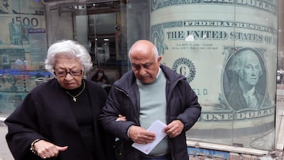 People outside a currency exchange office in Cairo. Egypt has devalued its pound three times since March 2022, and the currency has lost more than half its value since then. EPA