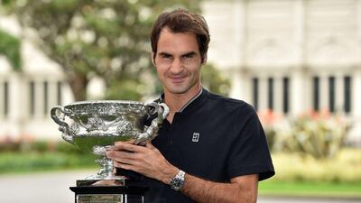 Roger Federer of Switzerland poses with the championship trophy during a photo opportunity the day after winning the Australian Open men's singles final for his 18th career Grand Slam in Melbourne on January 30, 2017. Saeed Khan / AFP