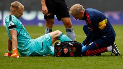 Arsenal's Aaron Ramsdale receives medical attention after sustaining an injury. Reuters