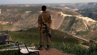 An Israeli soldier stands at a lookout in the Israel-annexed Golan Heights, overlooking southern Syria.AFP