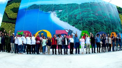 Filipino government officials wave to arriving tourists. EPA