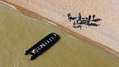 Migrants are escorted ashore in Kingsdown in Kent. An estimated 1,000 people made the crossing from France on Monday, September 6. AP Photo
