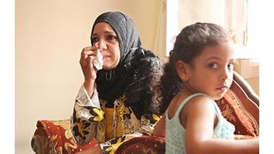 Magda Ali Hassan, the unofficial organiser of the protest group, cries as she talks about her detained son.