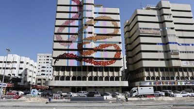 eL Seed’s first public artwork for the UAE covers the wall of an abandoned building in Sharjah. Sarah Dea / The National