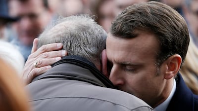 French President Emmanuel Macron gives his condolences to relatives of victims near the Bataclan concert venue at an event in 2017.
