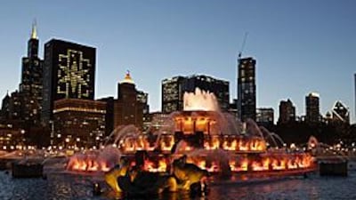 A Chicago 2016 emblem appears in lights of a high-rise building left, as the newly refurbished Buckingham Fountain welcomes the IOC's inspection committee on Tuesday.